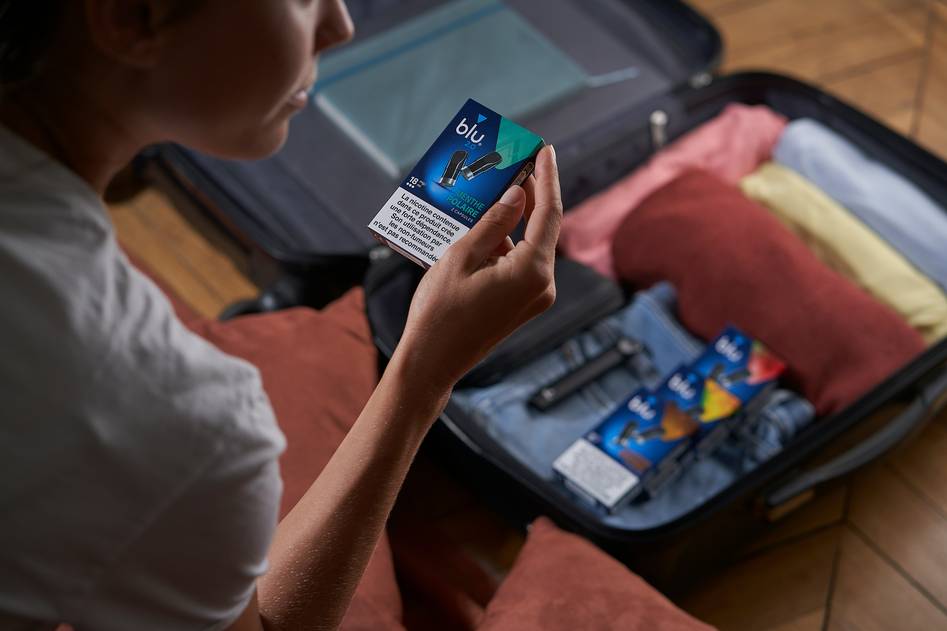 Person holding foreign currency and a passport, preparing for international travel